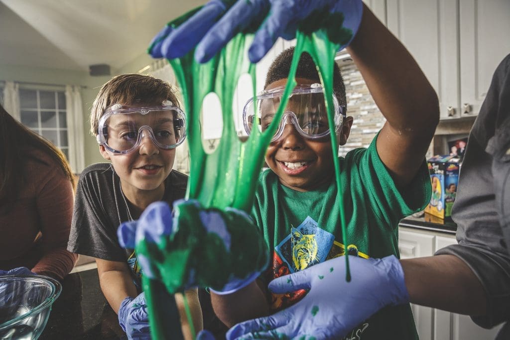 Two boys performing a science experiment with the Cub Scouts