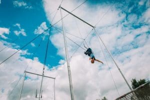 kid having swing on a high flying trapeze,