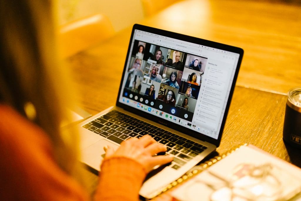 Managing Screen Time - woman on her computer in a group meeting