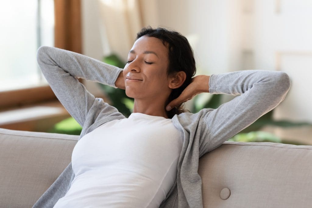 Close up of calm young African American woman relax sleep on sofa in living room with eyes closed. Relaxed biracial female rest on couch at home relieve negative emotions. Peace, stress free concept. - mom hacks