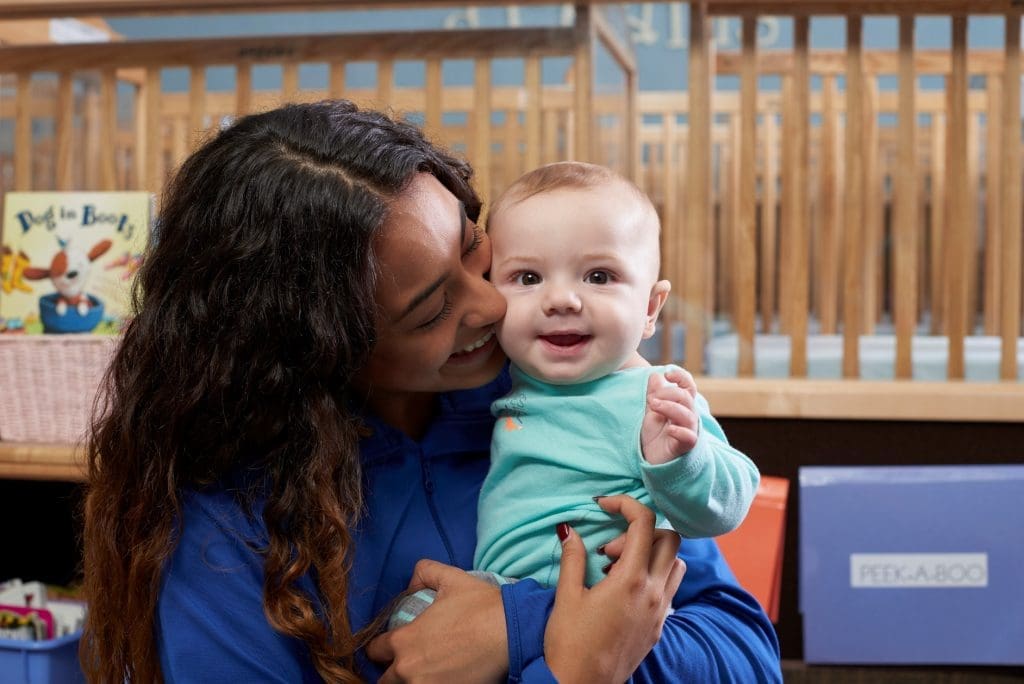 parents as brain builders - daycare worker with young child