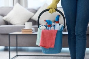 spring cleaning checklist- Shot of an unrecognizable woman holding a bucket of cleaning detergent before mopping her floors at home