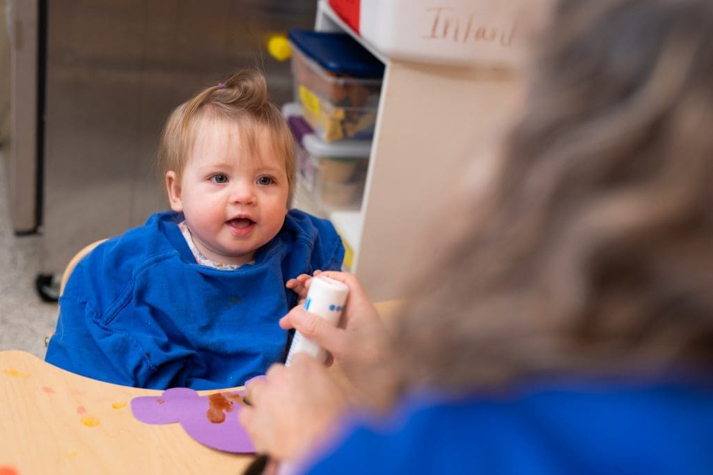child at daycare doing dot art