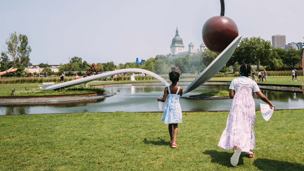 a child walking towards Spoonbridge and Cherry at the Walker Art Center